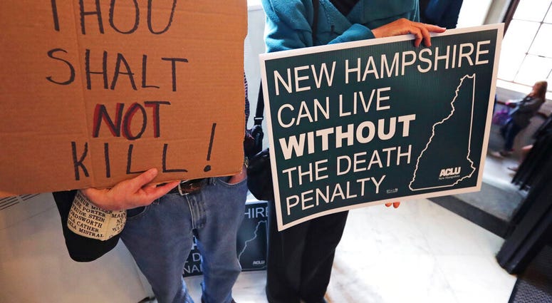 Protestors gather outside the Senate Chamber prior to a vote on the death penalty at the State House in Concord, N.H., Thursday, May 30, 2019.