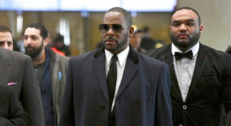 Musician R. Kelly, center, arrives at the Leighton Criminal Court building for a hearing in Chicago. Musician R. Kelly, center, arrives at the Leighton Criminal Court building for a hearing in Chicago.