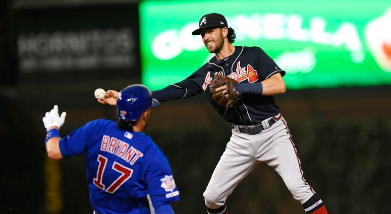 Atlanta Braves shortstop Dansby Swanson right, throws to first base after forcing out Chicago Cubs' Kris Bryant (17) at second base, on a double play hit into by Anthony Rizzo during the third inning of a baseball game Wednesday, June 26, 2019, in Chicago Atlanta Braves shortstop Dansby Swanson right, throws to first base after forcing out Chicago Cubs' Kris Bryant (17) at second base, on a double play hit into by Anthony Rizzo during the third inning of a baseball game Wednesday, June 26, 2019, in Chicago