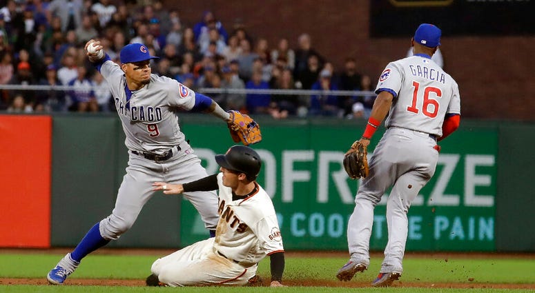 Chicago Cubs shortstop Javier Baez, left, throws to first base after forcing out San Francisco Giants' Mike Yastrzemski, center, at second base on a double play hit into by Pablo Sandoval during the fifth inning of a baseball game in San Francisco, Monday Chicago Cubs shortstop Javier Baez, left, throws to first base after forcing out San Francisco Giants' Mike Yastrzemski, center, at second base on a double play hit into by Pablo Sandoval during the fifth inning of a baseball game in San Francisco, Monday
