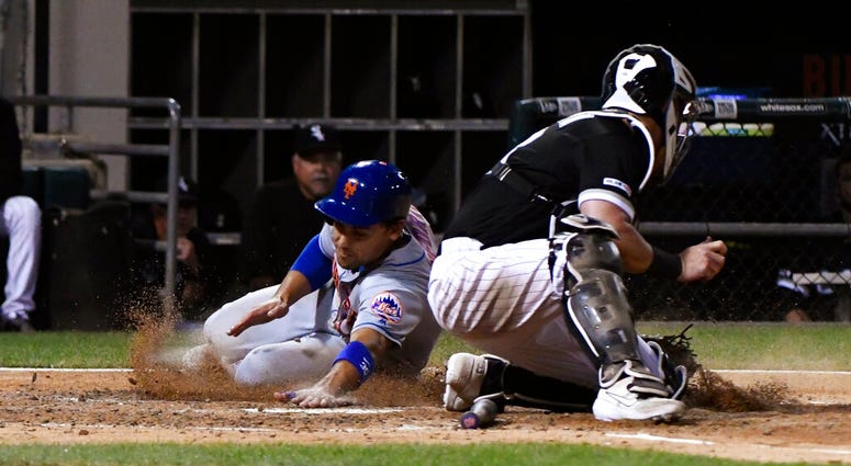 New York Mets' Michael Conforto, left, scores past Chicago White Sox catcher James McCann during the sixth inning of a baseball game Wednesday, July 31, 2019, in Chicago. New York Mets' Michael Conforto, left, scores past Chicago White Sox catcher James McCann during the sixth inning of a baseball game Wednesday, July 31, 2019, in Chicago.