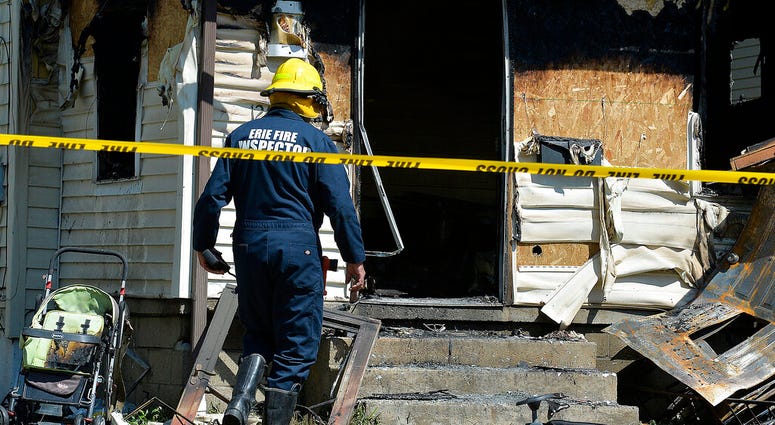 Erie Bureau of Fire Inspector Mark Polanski helps investigate a fatal fire at 1248 West 11th St. in Erie, Pa, on Sunday, Aug. 11, 2019. Erie Bureau of Fire Inspector Mark Polanski helps investigate a fatal fire at 1248 West 11th St. in Erie, Pa, on Sunday, Aug. 11, 2019.