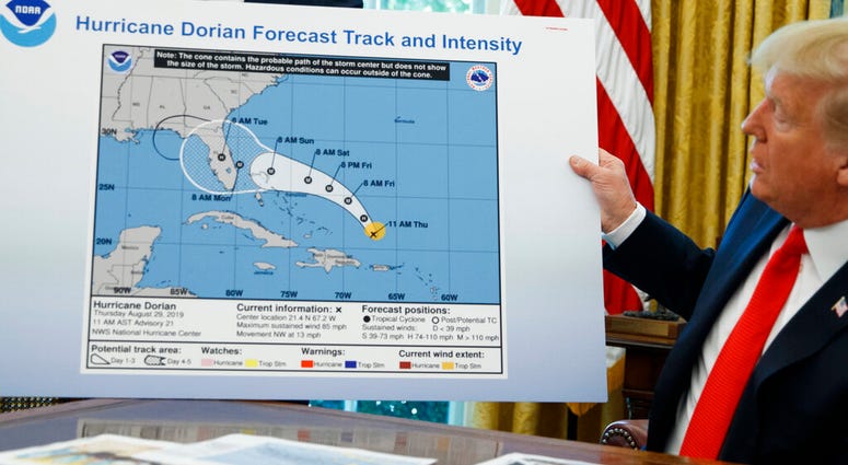 President Donald Trump holds a chart as he talks with reporters after receiving a briefing on Hurricane Dorian in the Oval Office of the White House, Wednesday, Sept. 4, 2019 President Donald Trump holds a chart as he talks with reporters after receiving a briefing on Hurricane Dorian in the Oval Office of the White House, Wednesday, Sept. 4, 2019