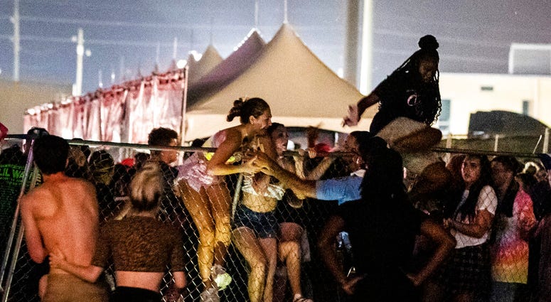 Festival-goers try to escape the crowd during Lil Wayne's fifth annual Lil WeezyAna Fest at the UNO Lakefront Arena grounds in New Orleans. Festival-goers try to escape the crowd during Lil Wayne's fifth annual Lil WeezyAna Fest at the UNO Lakefront Arena grounds in New Orleans.