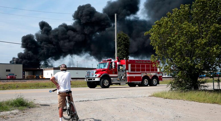 A resident watches as a firetruck arrives in downtown Dupo, Ill. to help fight a tanker fire from a derailed train on Tuesday, Sept. 10. 2019. A resident watches as a firetruck arrives in downtown Dupo, Ill. to help fight a tanker fire from a derailed train on Tuesday, Sept. 10. 2019.