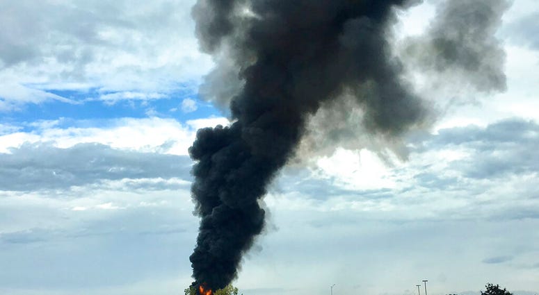 In this photo provided by Antonio Arreguin, smoke fills the sky after a World War II-era bomber plane crashed, Wednesday, Oct. 2, 2019 outside Bradley International Airport north of Hartford, Conn. A spokesman for Gov. Ned Lamont confirmed the crash of th In this photo provided by Antonio Arreguin, smoke fills the sky after a World War II-era bomber plane crashed, Wednesday, Oct. 2, 2019 outside Bradley International Airport north of Hartford, Conn.