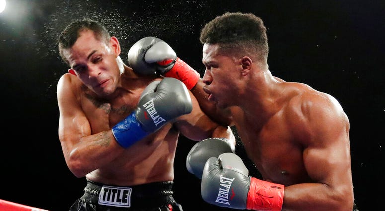 In this Oct. 27, 2018, file photo, Patrick Day, right, punches Elvin Ayala during the fifth round of a WBC super welterweight boxing bout in New York. In this Oct. 27, 2018, file photo, Patrick Day, right, punches Elvin Ayala during the fifth round of a WBC super welterweight boxing bout in New York.