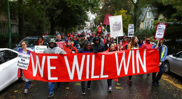 Dozens of Chicago Teachers Union members and supporters march through the streets of Chicago's Hyde Park neighborhood during the "Nurse in Every School" Solidarity March for Justice on Monday, Oct. 21, 2019. Dozens of Chicago Teachers Union members and supporters march through the streets of Chicago's Hyde Park neighborhood during the "Nurse in Every School" Solidarity March for Justice on Monday, Oct. 21, 2019.