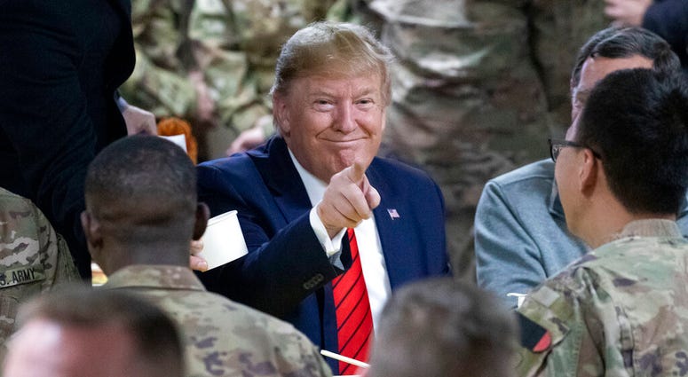 President Donald Trump speaks with members of the military during a surprise Thanksgiving Day visit, Thursday, Nov. 28, 2019, at Bagram Air Field, Afghanistan.