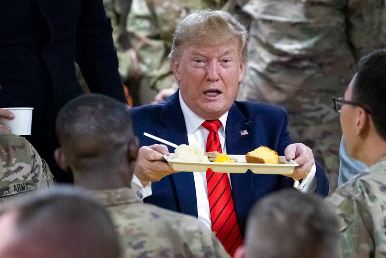 President Donald Trump speaks with members of the military during a surprise Thanksgiving Day visit, Thursday, Nov. 28, 2019, at Bagram Air Field, Afghanistan.