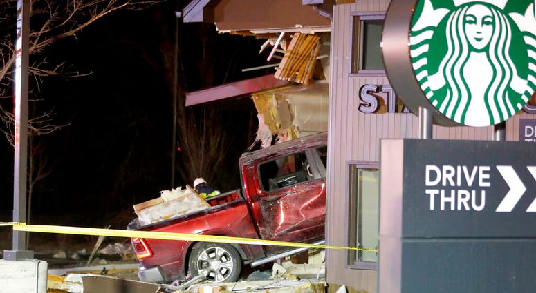 Personnel work at the scene in McHenry, Ill. where a vehicle drove into the Starbucks Thursday, Jan. 16, 2020. Personnel work at the scene in McHenry, Ill. where a vehicle drove into the Starbucks Thursday, Jan. 16, 2020.