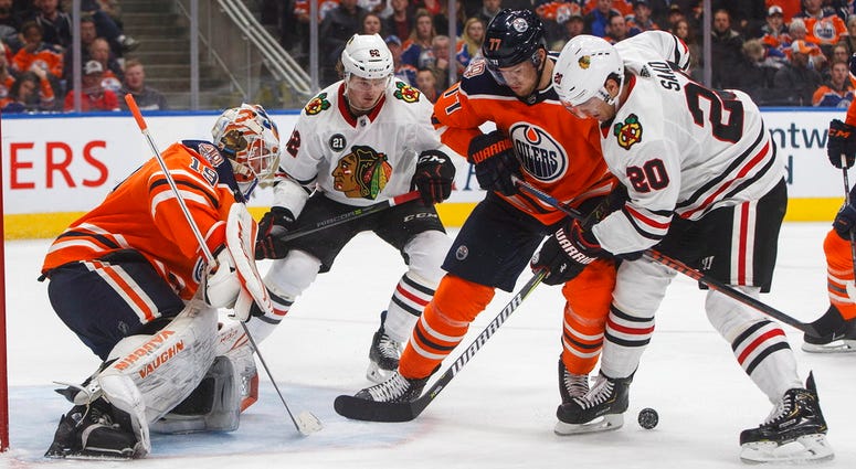Chicago Blackhawks' Brandon Saad (20) and Edmonton Oilers' Oscar Klefbom (77) battle for the rebound from Edmonton Oilers' goalie Mikko Koskinen (19) as Luke Johnson (62) skates in during third period NHL hockey action in Edmonton, Alberta, on Thursday. Chicago Blackhawks' Brandon Saad (20) and Edmonton Oilers' Oscar Klefbom (77) battle for the rebound from Edmonton Oilers' goalie Mikko Koskinen (19) as Luke Johnson (62) skates in during third period NHL hockey action in Edmonton, Alberta.