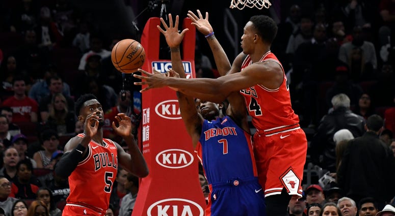 Bulls center Wendell Carter Jr. (34) passes the ball to forward Bobby Portis (5) as Pistons forward Stanley Johnson (7) defends. Bulls center Wendell Carter Jr. (34) passes the ball to forward Bobby Portis (5) as Pistons forward Stanley Johnson (7) defends.