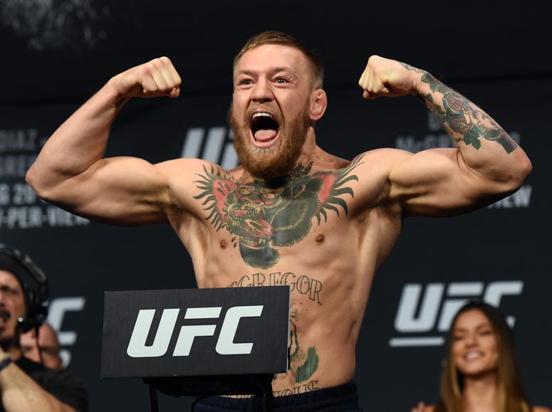 UFC featherweight champion Conor McGregor poses on the scale during his weigh-in for UFC 202 at MGM Grand Conference Center on August 19, 2016 in Las Vegas, Nevada. UFC featherweight champion Conor McGregor poses on the scale during his weigh-in for UFC 202 at MGM Grand Conference Center on August 19, 2016 in Las Vegas, Nevada.