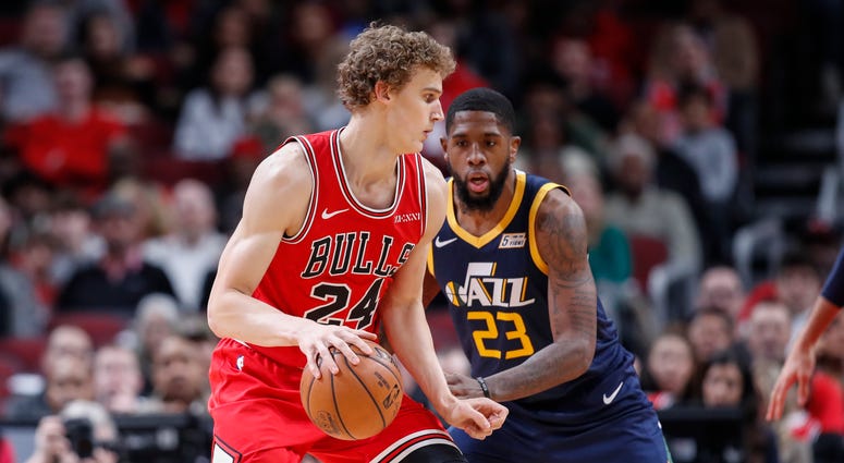 Lauri Markkanen (24) controls the ball defended by Utah Jazz forward Royce O'Neale