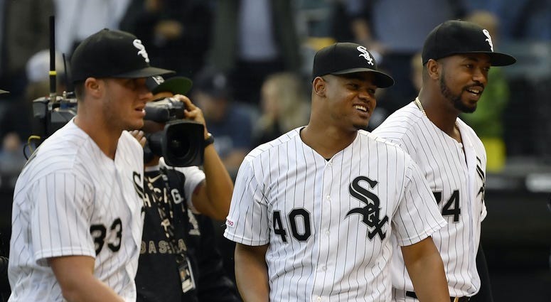 Sep 28, 2019; Chicago, IL, USA; Chicago White Sox starting pitcher Reynaldo Lopez (40), Chicago White Sox designated hitter Eloy Jimenez (74), and teammates celebrate the 7-1 win against the Detroit Tigers at Guaranteed Rate Field. Sep 28, 2019; Chicago, IL, USA; Chicago White Sox starting pitcher Reynaldo Lopez (40), Chicago White Sox designated hitter Eloy Jimenez (74), and teammates celebrate the 7-1 win against the Detroit Tigers at Guaranteed Rate Field.