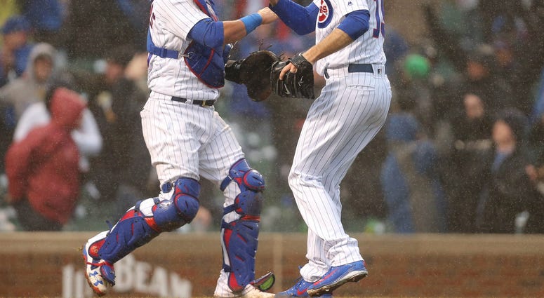 Chicago Cubs relief pitcher Brandon Morrow (15) and catcher Willson Contreras (40) Apr 14, 2018; Chicago, IL, USA; Chicago Cubs relief pitcher Brandon Morrow (15) and catcher Willson Contreras (40) celebrate after the final out of the ninth inning against the Atlanta Braves at Wrigley Field. Chicago won 14-10.