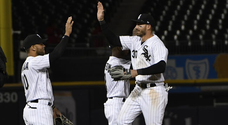 Chicago White Sox second baseman Yoan Moncada (10) and left fielder Nicky Delmonico (30) celebrate their win against the Seattle Mariners at Guaranteed Rate Field.
