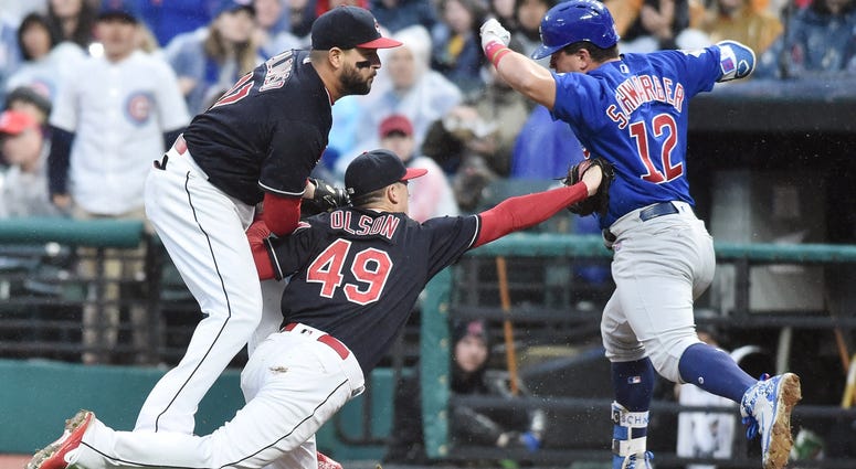 Cleveland Indians relief pitcher Tyler Olson (49) tags out Chicago Cubs designated hitter Kyle Schwarber (12) during the sixth inning at Progressive Field.