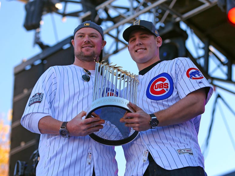 Chicago Cubs starting pitcher Jon Lester (left) and first baseman Anthony Rizzo (right) hold the Commissioner's Trophy during the World Series victory rally in Grant Park.