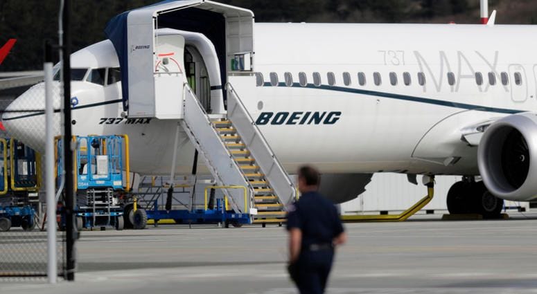 File photo, a worker walks next to a Boeing 737 MAX 8 airplane parked at Boeing Field in Seattle. U.S. aviation regulators said Monday, April 1, Boeing needs more time to finish changes in a flight-control system suspected of playing a role in two deadly File photo, a worker walks next to a Boeing 737 MAX 8 airplane parked at Boeing Field in Seattle. U.S. aviation regulators said Monday, April 1, Boeing needs more time to finish changes in a flight-control system suspected of playing a role in two deadly