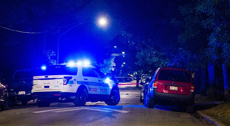 Police investigate the scene where 5 people were wounded in a shooting Sunday night in the 7400 block of South Dante.
