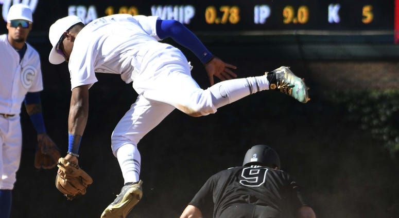 Chicago Cubs second baseman Tony Kemp (21) jumps out of the way after tagging out Washington Nationals second baseman Brian Dozier (9) on a steal attempt of second base. Chicago Cubs second baseman Tony Kemp (21) jumps out of the way after tagging out Washington Nationals second baseman Brian Dozier (9) on a steal attempt of second base.
