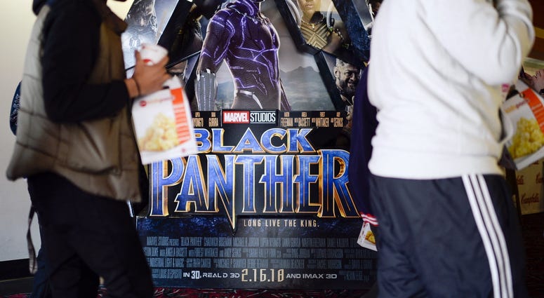 Feb. 15, 2018; Cherry Hill, NJ, USA; Students walk past a 'Black Panther' poster as a special screening is set to begin as part of an event organized by Campbell Soup Company's Black Resource Group at AMC Loews.