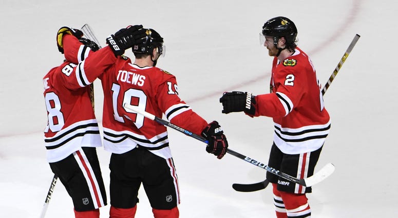 Mar 6, 2018; Chicago, IL, USA; Chicago Blackhawks center Jonathan Toews (19) celebrates his game winning goal against the Colorado Avalanche with right wing Patrick Kane (88) and defenseman Duncan Keith (2) during the overtime period at United Center.
