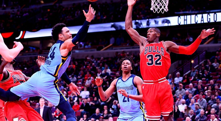 Mar 7, 2018; Chicago, IL, USA; Memphis Grizzlies forward Dillon Brooks (24) shoots the ball against Chicago Bulls guard Kris Dunn (32) during the second half at the United Center.