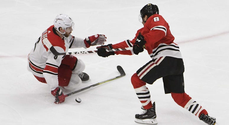 Mar 8, 2018; Chicago, IL, USA; Carolina Hurricanes defenseman Klas Dahlbeck (6) defends Chicago Blackhawks center Nick Schmaltz (8) during the third period at United Center.
