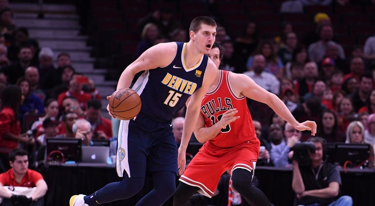 Mar 21, 2018; Chicago, IL, USA; Denver Nuggets center Nikola Jokic (15) dribbles the ball against Chicago Bulls forward Paul Zipser (16) during the first half at the United Center.