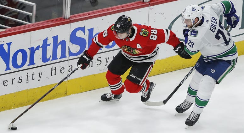 Mar 22, 2018; Chicago, IL, USA; Vancouver Canucks defenseman Alexander Edler (23) collides with Chicago Blackhawks center Matthew Highmore (36) during the third period at United Center.