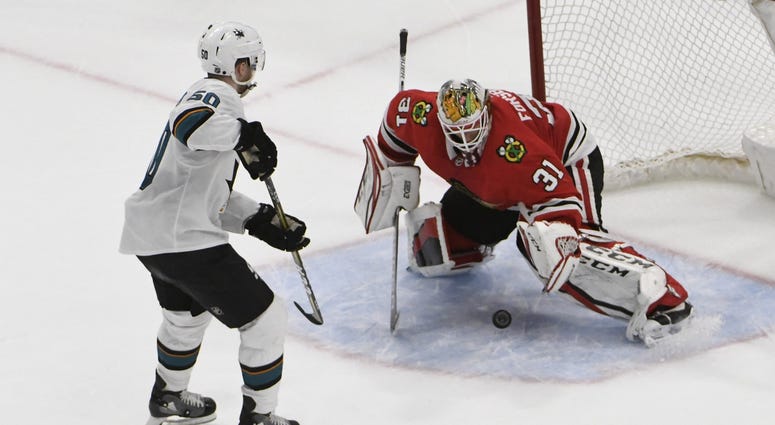Mar 26, 2018; Chicago, IL, USA; Chicago Blackhawks goaltender Anton Forsberg (31) makes a save on San Jose Sharks center Chris Tierney (50) during a shootout at United Center.