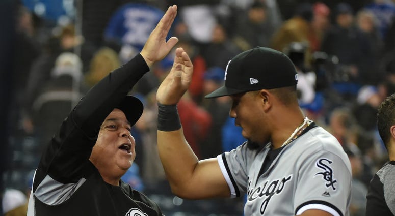 Apr 4, 2018; Toronto, Ontario, CAN; Chicago White Sox manager Rick Renteria (17) slaps hands with designated hitter Jose Abreu (79) as they celebrate a 4-3 win over Toronto Blue Jays at Rogers Centre.