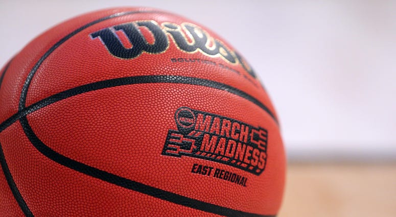 A view of the March Madness logo on a basketball drives to the basket between the Florida Gators and the Wisconsin Badgers in the semifinals of the East Regional of the 2017 NCAA Tournament at Madison Square Garden.