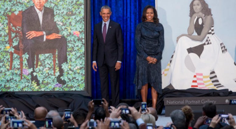 Former President Barack Obama and First Lady Michelle Obama stand beside their portraits after their unveiling at the Smithsonian’s National Portrait Gallery in Washington, DC, February 12, 2018.