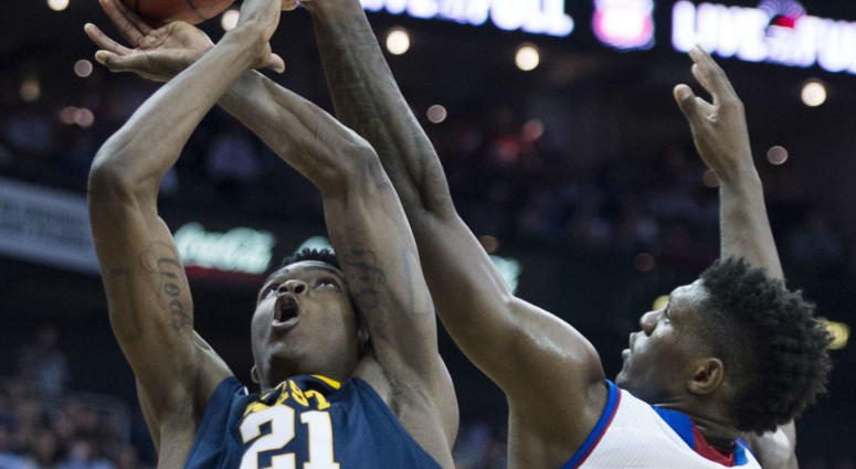 KU's Silvio De Sousa (22) knocks the ball out of the hands of West Virginia's Wesley Harris (21) during the first half in the Big 12 Tournament championship game at the Sprint Center in Kansas City, Mo., on Saturday, March 10, 2018.