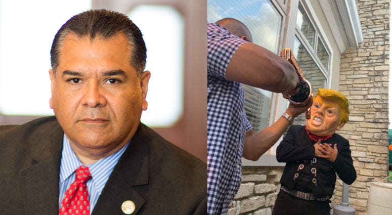 State Senator Martin Sandoval and photo posted on social showing a man in a Donald Trump mask clutching his chest, and another man pretending to shoot him State Senator Martin Sandoval and photo posted on social showing a man in a Donald Trump mask clutching his chest, and another man pretending to shoot him