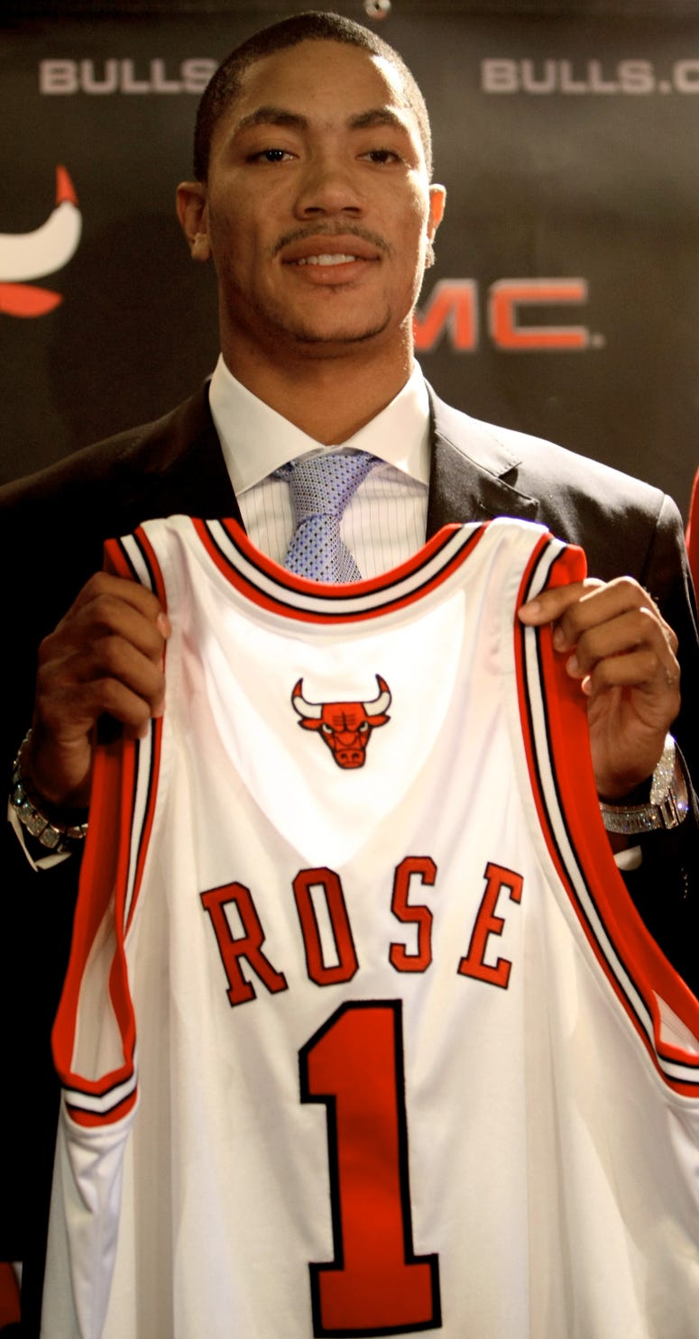 Chicago Bulls draft pick Derrick Rose holds up his Bulls jersey at a press conference at the United Center on Monday, June 30, 2008