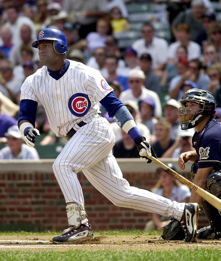 Sammy Sosa hits a home run in the first inning of his team's game against the Milwaukee Brewers at Wrigley Field on Wednesday, August 22, 2001.
