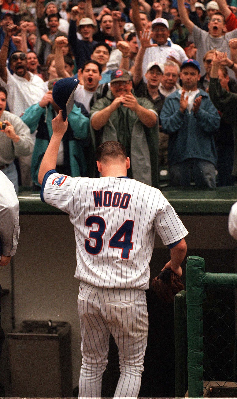Chicago Cubs pitcher Kerry Wood tips his cap to the fans at Wrigley Field after throwing his 20th strikeout during Wednesday's game against the Houston Astros.