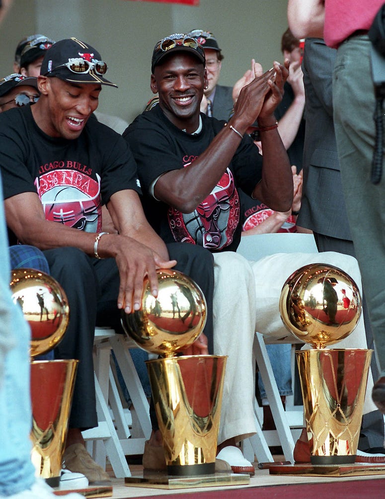 Chicago Bulls' Scottie Pippen, left, and Michael Jordan show off their trophies Tuesday during the Bulls' championship rally at Grant Park in Chicago.