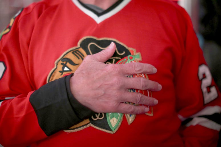 A man covered his heart during the national anthem at the United Center