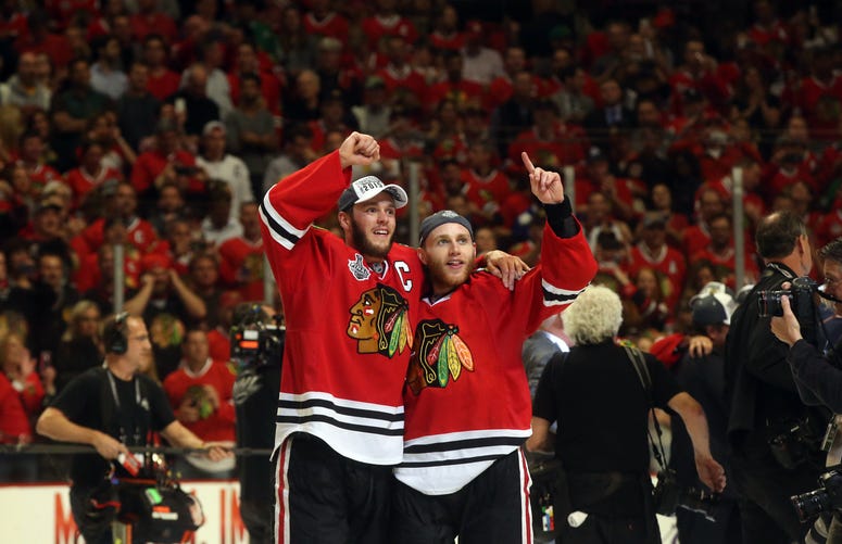 The Chicago Blackhawks' Jonathan Toews, left, and Patrick Kane celebrate on June 15, 2015, after eliminating the Tampa Bay Lightning in Game 6 of the Stanley Cup Final at United Center in Chicago.