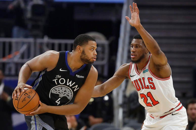 Chicago Bulls guard Kris Dunn drives against Golden State Warriors guard Alec Burks.
