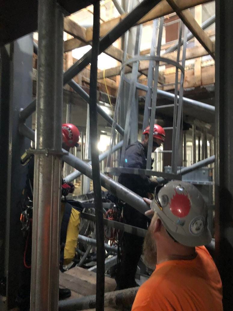 Evanston firefighters work to bring a crane operator down from his post after a fatal construction accident in the 800 block of Emerson Street in Evanston.