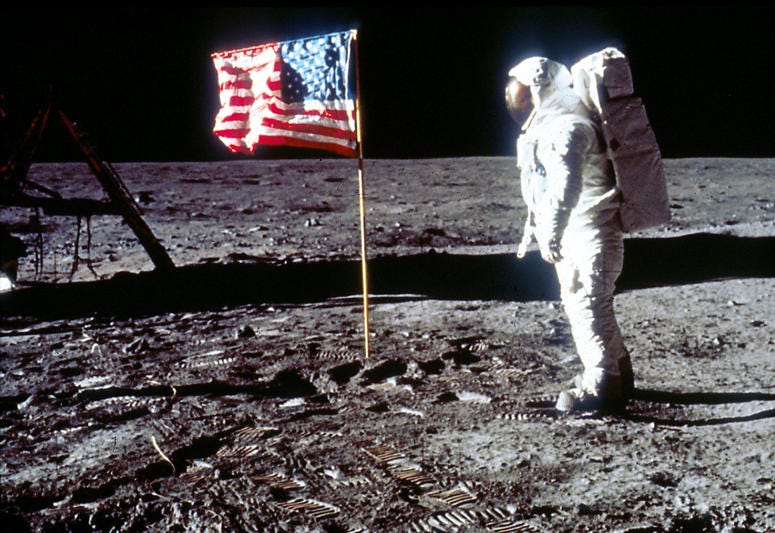 Astronaut Edwin "Buzz" Aldrin poses next to the U.S. flag July 20, 1969 on the moon during the Apollo 11 mission. Astronaut Edwin "Buzz" Aldrin poses next to the U.S. flag July 20, 1969 on the moon during the Apollo 11 mission.