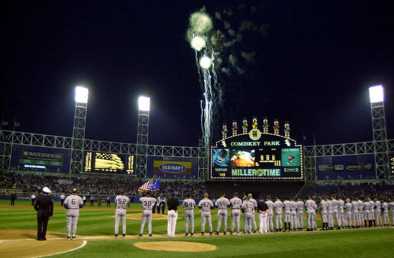 Members of the New York Yankees watch as fireworks explode over Comiskey Park before a game against the Chicago White Sox in Chicago, Illinois. Members of the New York Yankees watch as fireworks explode over Comiskey Park before a game against the Chicago White Sox in Chicago, Illinois.
