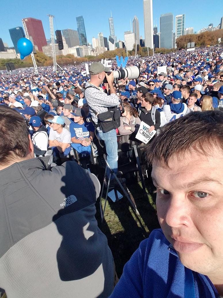 Rick Gregg attempts a selfie during Cubs Championship Rally